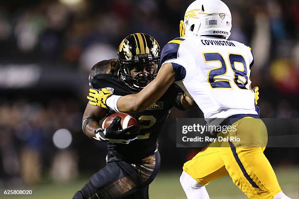 Jamauri Bogan of the Western Michigan Broncos runs the ball against Aaron Covington of the Toledo Rockets in the fourth quarter at Waldo Stadium on...