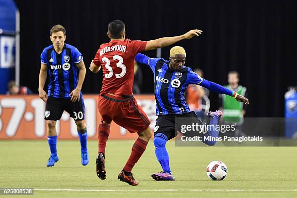 Ambroise Oyongo of the Montreal Impact prepares to kick the ball in front of Steven Beitashour of the Toronto FC during leg one of the MLS Eastern...