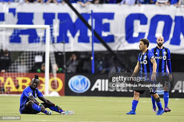 Dominic Oduro of the Montreal Impact sits on the pitch as teammate Hernan Bernardello walks towards him during leg one of the MLS Eastern Conference...