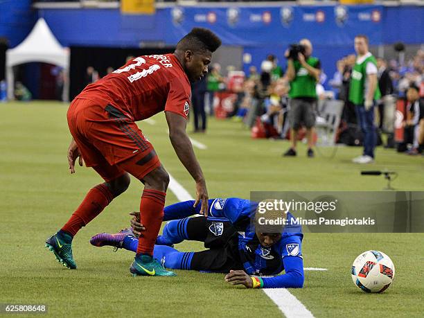 Armando Cooper of the Toronto FC challenges Ambroise Oyongo of the Montreal Impact during leg one of the MLS Eastern Conference finals at Olympic...