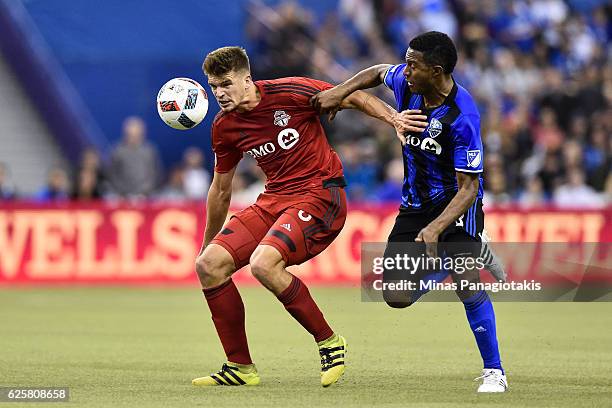 Patrice Bernier of the Montreal Impact challenges Nick Hagglund of the Toronto FC during leg one of the MLS Eastern Conference finals at Olympic...