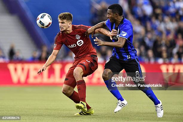 Patrice Bernier of the Montreal Impact challenges Nick Hagglund of the Toronto FC during leg one of the MLS Eastern Conference finals at Olympic...