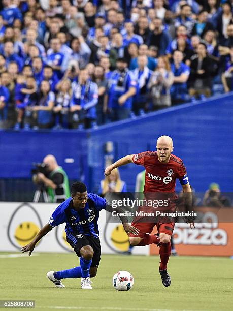 Patrice Bernier of the Montreal Impact and Michael Bradley of the Toronto FC chase the ball during leg one of the MLS Eastern Conference finals at...