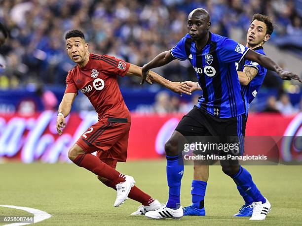 Justin Morrow of the Toronto FC breaks free from Hassoun Camara of the Montreal Impact during leg one of the MLS Eastern Conference finals at Olympic...