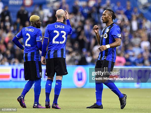 Didier Drogba of the Montreal Impact consults with teammates Laurent Ciman and Ambroise Oyongo during leg one of the MLS Eastern Conference finals...