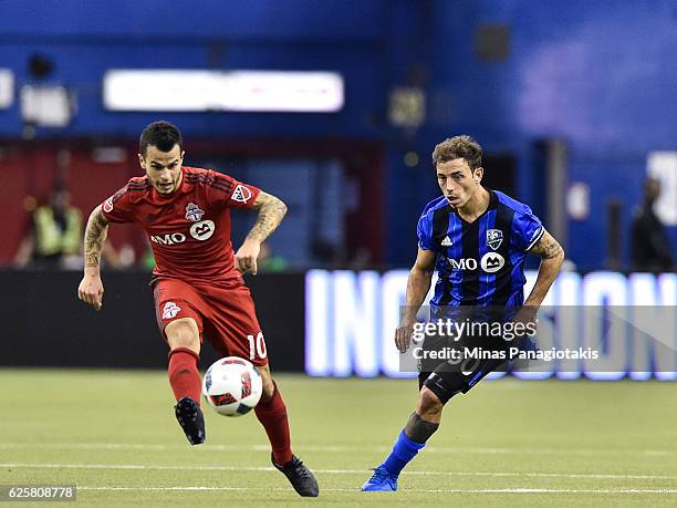 Hernan Bernardello of the Montreal Impact chases the ball after Sebastian Giovinco of the Toronto FC kicks it during leg one of the MLS Eastern...