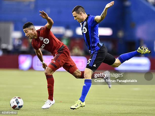 Donny Toia of the Montreal Impact challenges Justin Morrow of the Toronto FC during leg one of the MLS Eastern Conference finals at Olympic Stadium...