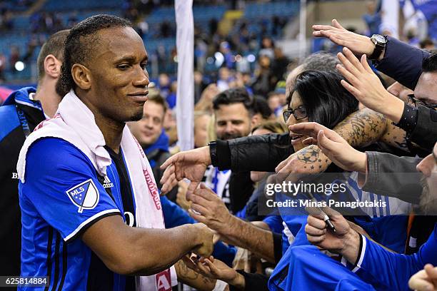 Didier Drogba of the Montreal Impact celebrates with fans during leg one of the MLS Eastern Conference finals against the Toronto FC at Olympic...