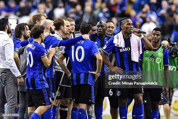 Members of the Montreal Impact honour teammate Didier Drogba as he addresses the fans during leg one of the MLS Eastern Conference finals against the...