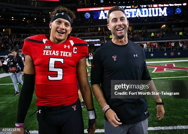 Texas Tech quarterback Patrick Mahomes II and head coach Kliff Kingsbury walk off the field after after a 54-35 win against Baylor at AT&T Stadium in...