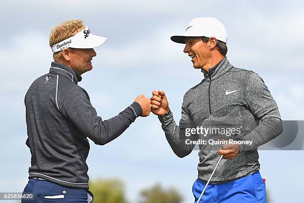 Soren Kjeldsen and Thorbjorn Olesen of Denmark celebrate a birdie during day three of the World Cup of Golf at Kingston Heath Golf Club on November...