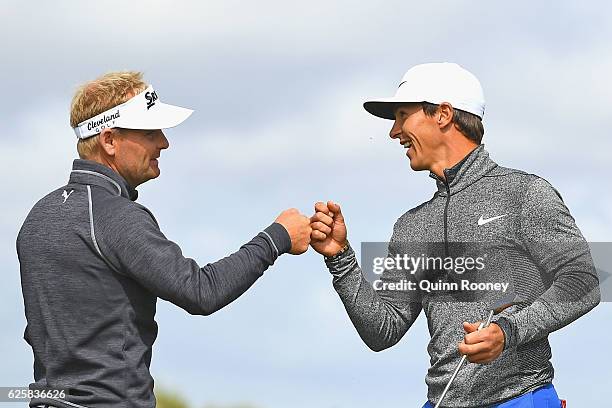 Soren Kjeldsen and Thorbjorn Olesen of Denmark celebrate a birdie during day three of the World Cup of Golf at Kingston Heath Golf Club on November...