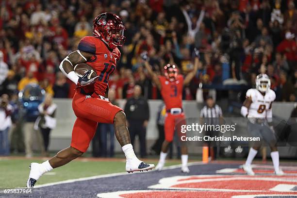 Wide receiver Samajie Grant of the Arizona Wildcats scores a nine yard rushing touchdown against the Arizona State Sun Devils during the third...