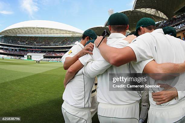 Australian players huddle during day three of the Third Test match between Australia and South Africa at Adelaide Oval on November 26, 2016 in...