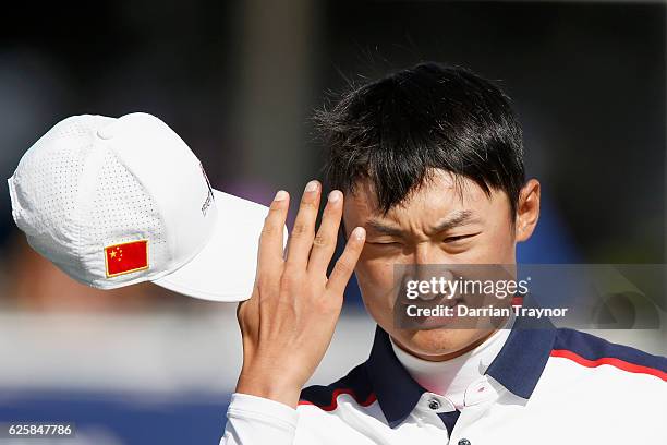 Haotong of China takes his cap off after his round day three of the World Cup of Golf at Kingston Heath Golf Club on November 26, 2016 in Melbourne,...