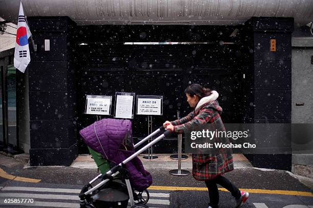 Korean woman passes the house where Park's family lived from May 1958, when his father, former president Park Chung-hee was a brigadier in the army,...