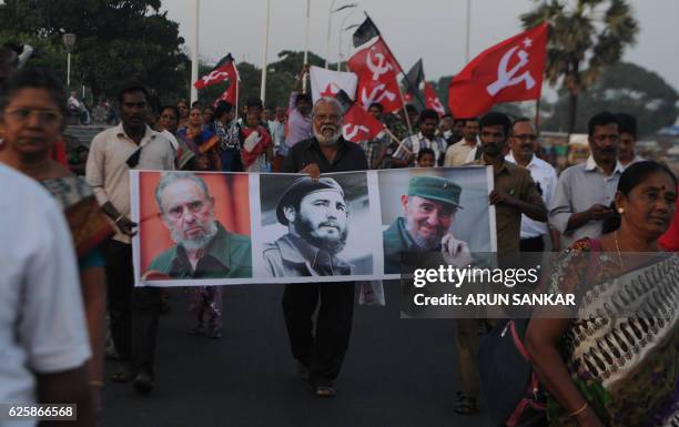 Indian members of Communist Party of India carry placards bearing the image of former Cuban president Fidel Castro during a remembrance rally in...