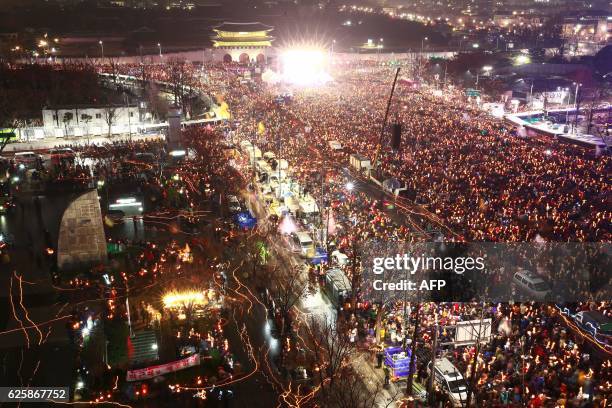 South Korean protesters take part in a candlelight procession towards the presidential house during a rally against South Korean President Park...