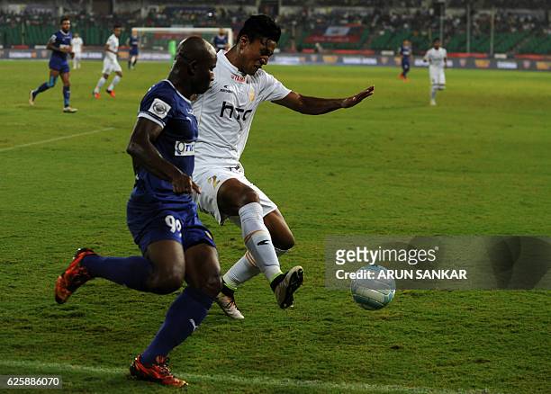 Chennaiyin FC's forward Dudu Omagbemi vies for the ball against NorthEast United FC's defender Salam Ranjan Singh during the Indian Super League...