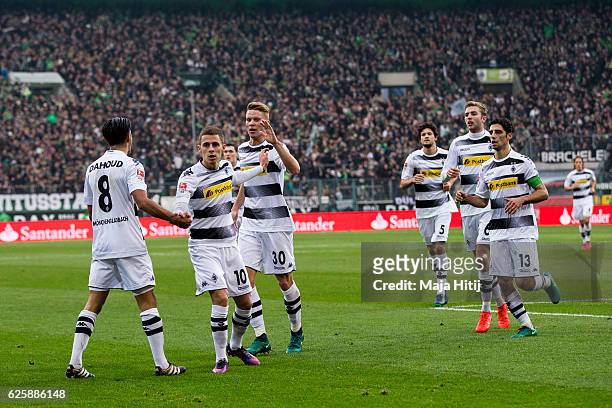 Mahmoud Dahoud of Moenchengladbach celebrates with teammates after scoring a goal to make it 1-0 during the Bundesliga match between Borussia...