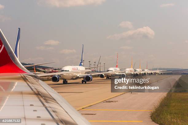 airplanes waiting line to take-off at sabiha-gokcen airport istanbul turkey - airport runway stock pictures, royalty-free photos & images