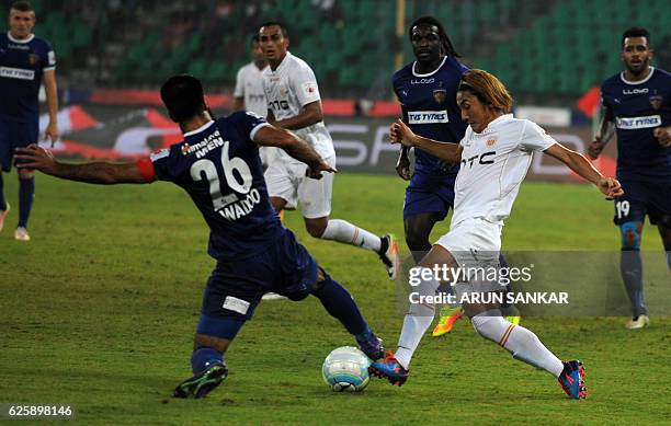 NorthEast United FC's Katsumi Yusa vies for the ball against Chennaiyin FC's defender Mehrajuddin Wadoo during the Indian Super League football match...