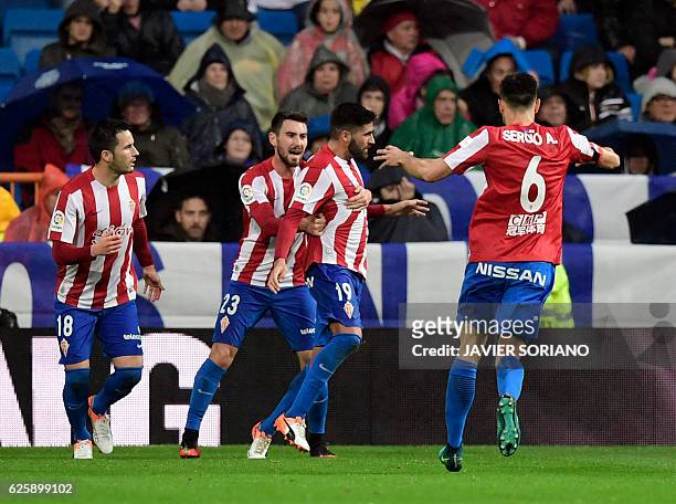 Sporting Gijon's midfielder Carlos Carmona celebrates a goal with teammates during the Spanish league football match Real Madrid CF vs Real Sporting...