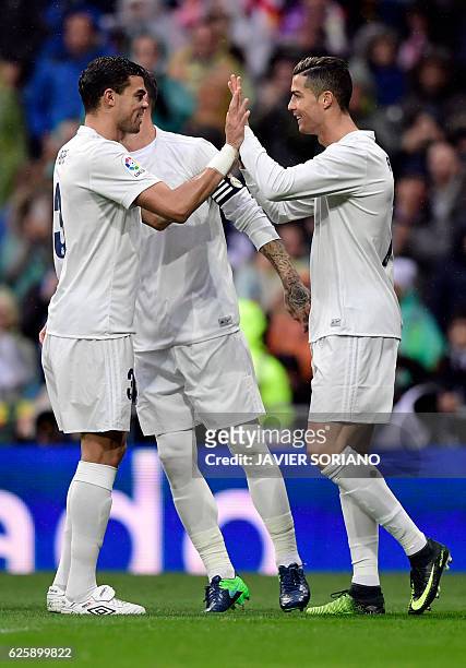 Real Madrid's Portuguese forward Cristiano Ronaldo celebrates the opening goal with teammate Real Madrid's Portuguese defender Pepe during the...