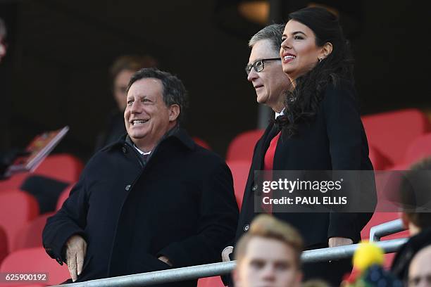 Liverpool Chairman Tom Werner, Liverpool's US owner John W. Henry and Henry's film producer wife Linda Pizzuti take their places for the English...