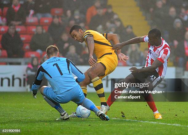 Lincoln Citys Theo Robinson is denied by Maidstone United's Lee Worgan and Maidstone United's Kevin Lokko during the Vanarama National League match...