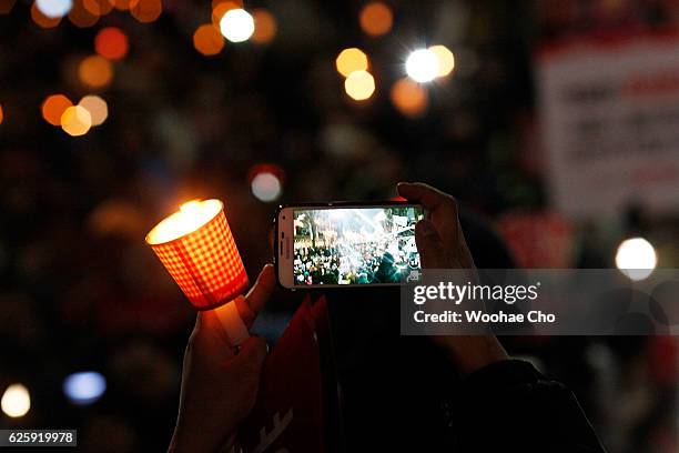 Masses of protesters gathered and occupy major streets in the city center for a rally against South Korean President Park Geun-hye on November 26,...