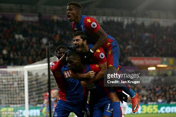 Christian Benteke of Crystal Palace celebrates scoring his team's fourth goal with his team mates during the Premier League match between Swansea...