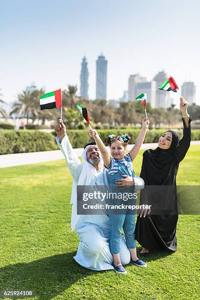 happy emirate family celebrate the national day - 9 11 flag stock pictures, royalty-free photos & images