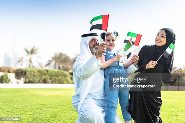 happy emirate family celebrate the national day - public celebratory event stock pictures, royalty-free photos & images