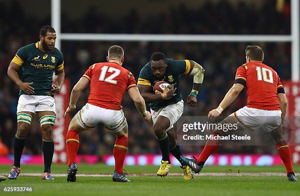 Tendai Mtawarira of South Africa takes on Scott Williams and Dan Biggar of Wales during the international match between Wales and South Africa at...