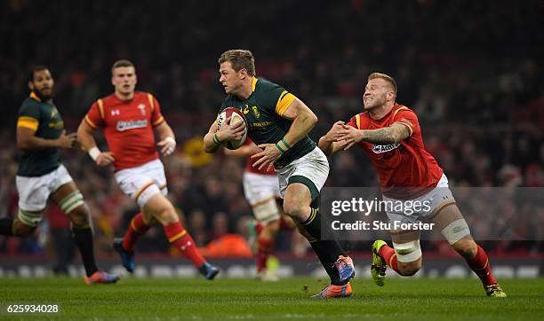 Springboks player Ruan Combrinck escapes the clutches of Ross Moriarty of Wales during the International match between Wales and South Africa at...