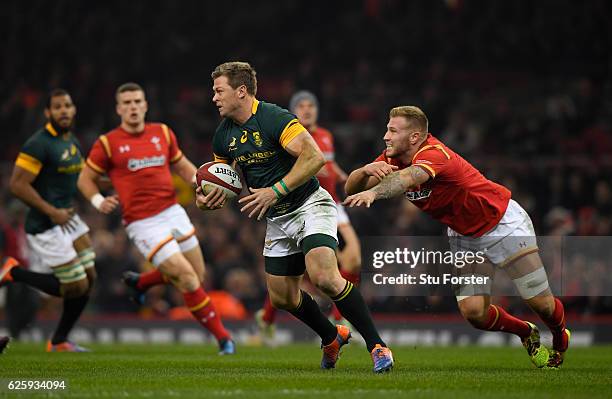 Springboks player Ruan Combrinck escapes the clutches of Ross Moriarty of Wales during the International match between Wales and South Africa at...