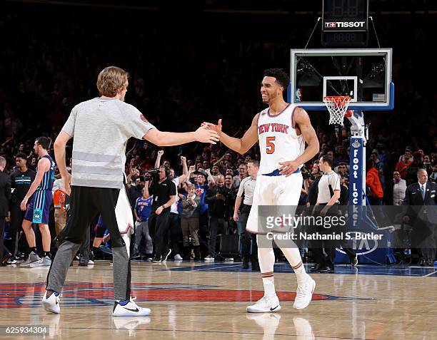 Courtney Lee and Ron Baker of the New York Knicks high five during the game against the Charlotte Hornets at Madison Square Garden in New York, New...