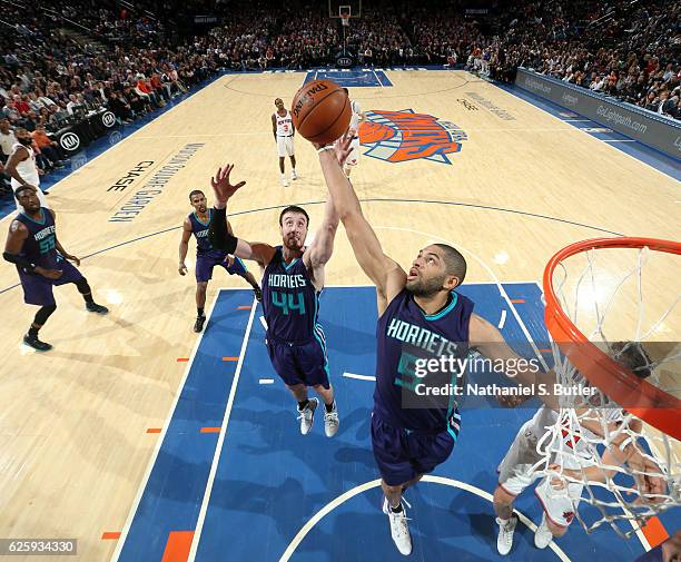 Nicolas Batum and Frank Kaminsky III of the Charlotte Hornets go up for a rebound against the New York Knicks at Madison Square Garden in New York,...