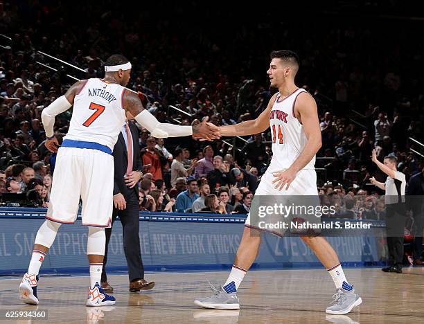 Carmelo Anthony and Willy Hernangomez of the New York Knicks high five during the game against the Charlotte Hornets at Madison Square Garden in New...