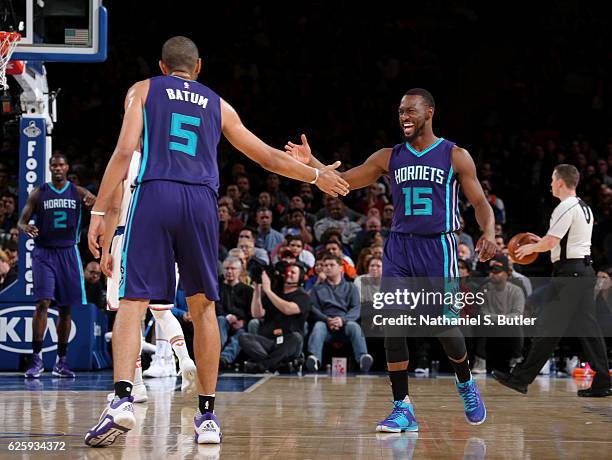 Nicolas Batum and Kemba Walker of the Charlotte Hornets high five during the game against the New York Knicks at Madison Square Garden in New York,...