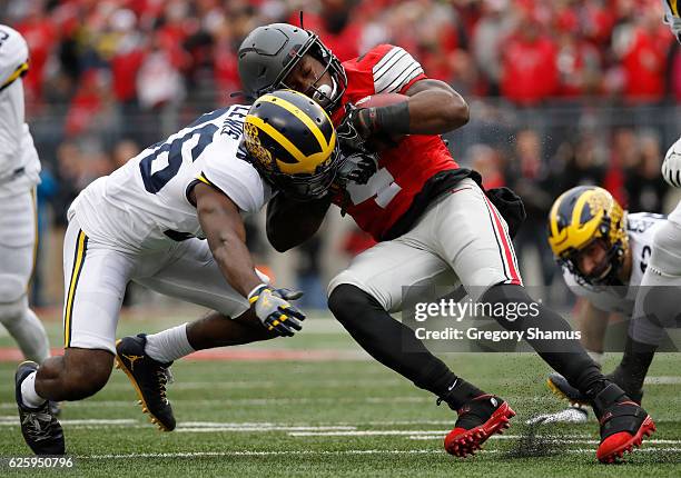 Curtis Samuel of the Ohio State Buckeyes is tackled by Jourdan Lewis of the Michigan Wolverines during the first half of their game at Ohio Stadium...