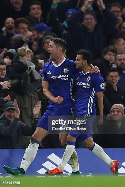Pedro of Chelsea celebrates scoring his team's first goal with his team mate Gary Cahill during the Premier League match between Chelsea and...