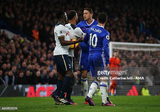 Nemanja Matic of Chelsea and Victor Wanyama of Tottenham Hotspur are kept apart by their team mates during the Premier League match between Chelsea...