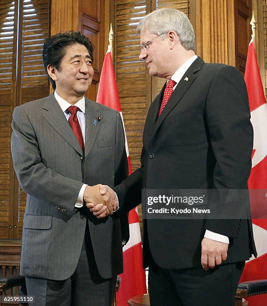 Canada - Japanese Prime Minister Shinzo Abe shakes hands with Canadian Prime Minister Stephen Harper ahead of their talks in Ottawa on Sept. 24, 2013.
