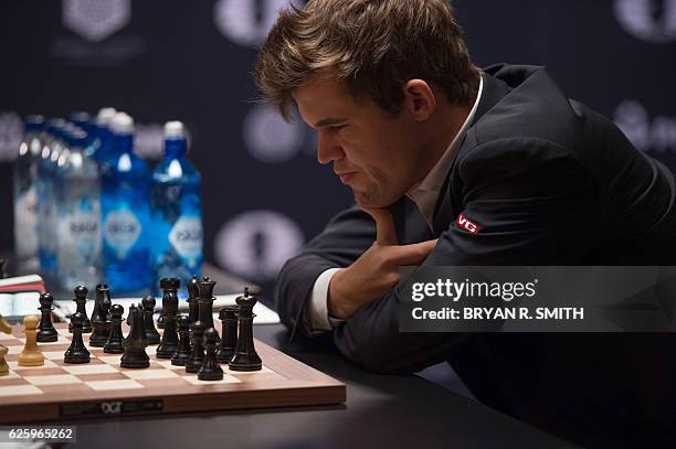 Magnus Carlsen, Norwegian chess grandmaster and current World Chess Champion, plays against Sergey Karjakin, Russian chess grandmaster, during round...