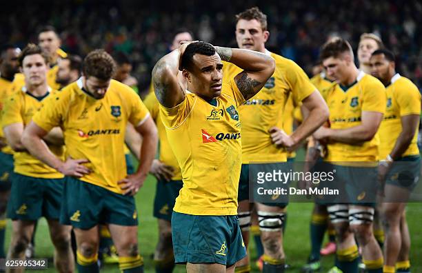 Will Genia of Australia stands dejected amongst his team mates following their defeat during the international match between Ireland and Australia at...