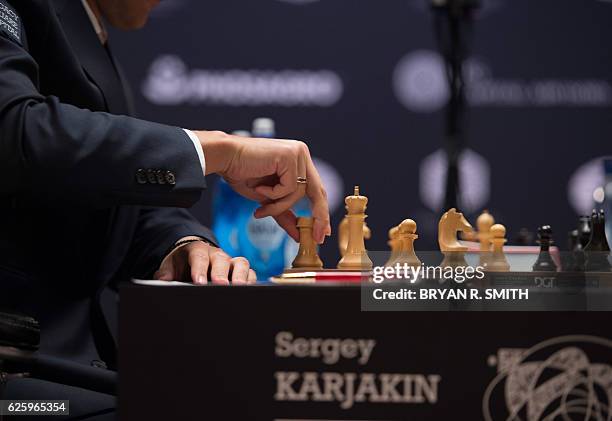 Sergey Karjakin, Russian chess grandmaster, makes a move against Magnus Carlsen, Norwegian chess grandmaster and current World Chess Champion during...