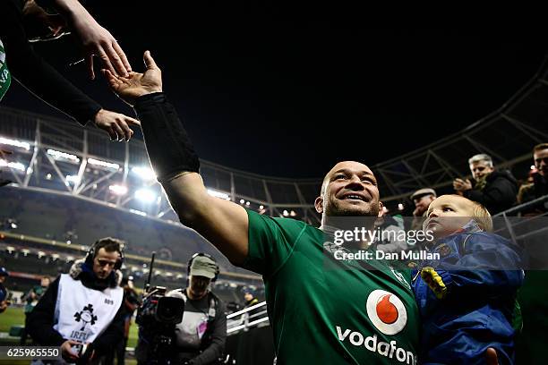 Rory Best of Ireland leaves the field with his son Richie following his 100th cap and his side's victory during the international match between...