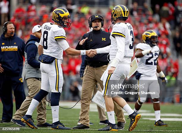 Head coach Urban Meyer of the Ohio State Buckeyes celebrates with quarterbacks Wilton Speight and John O'Korn after a big play against the Ohio State...